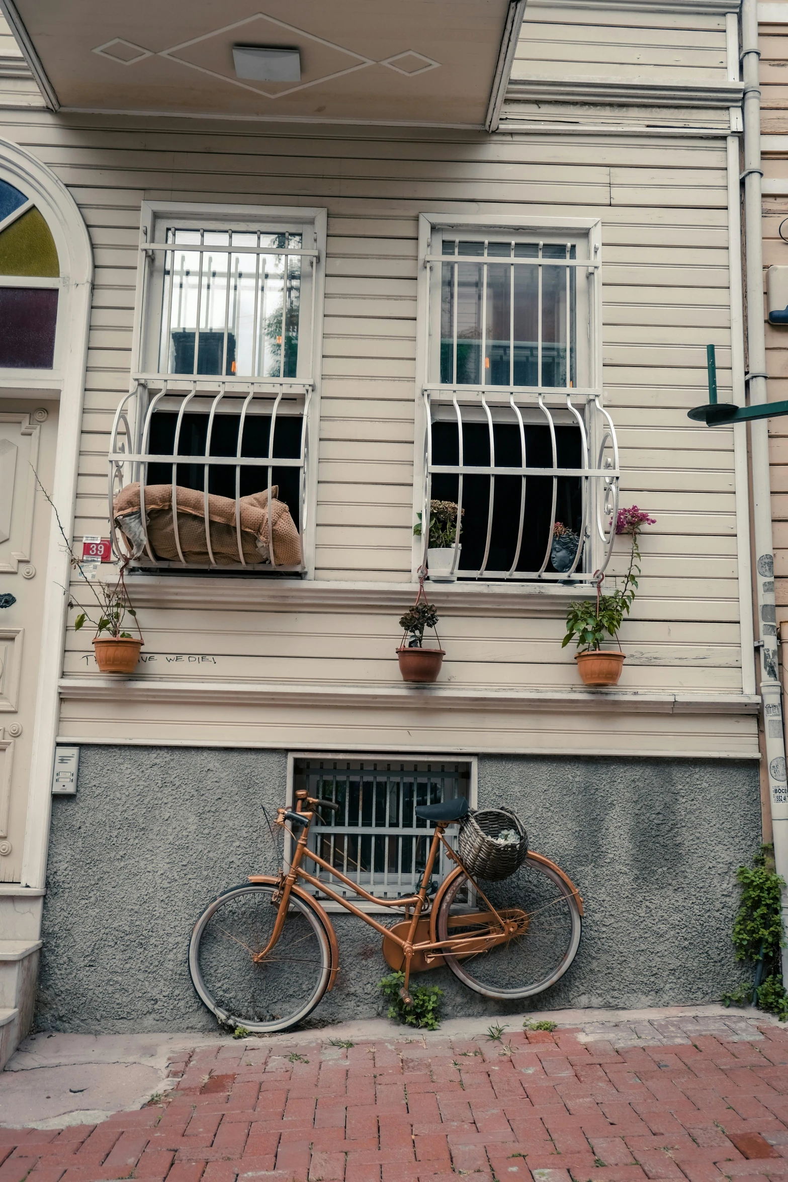 a bicycle parked up against the side of a building