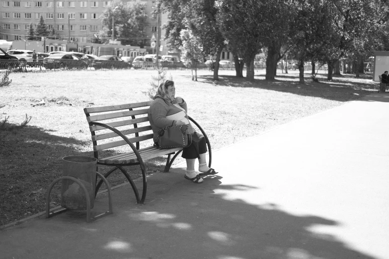 a woman on a bench in a park