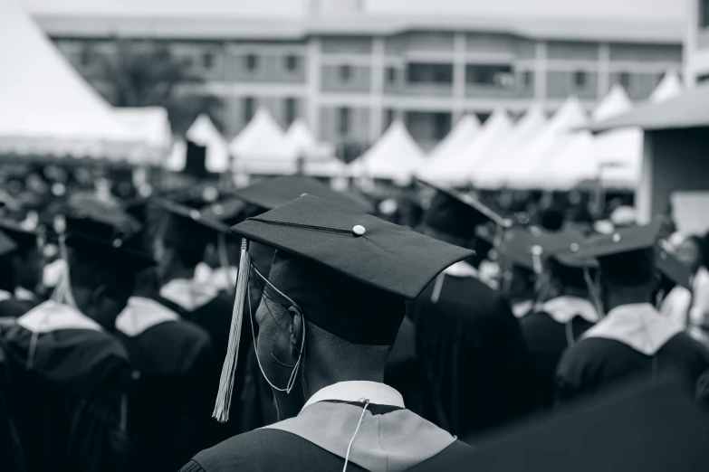 there is a large group of graduates standing in line