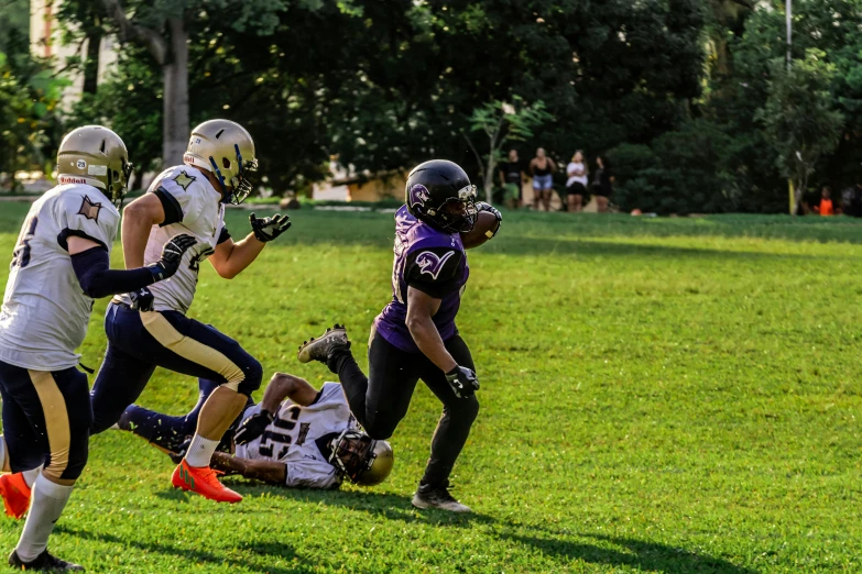 players running for the football game on a field