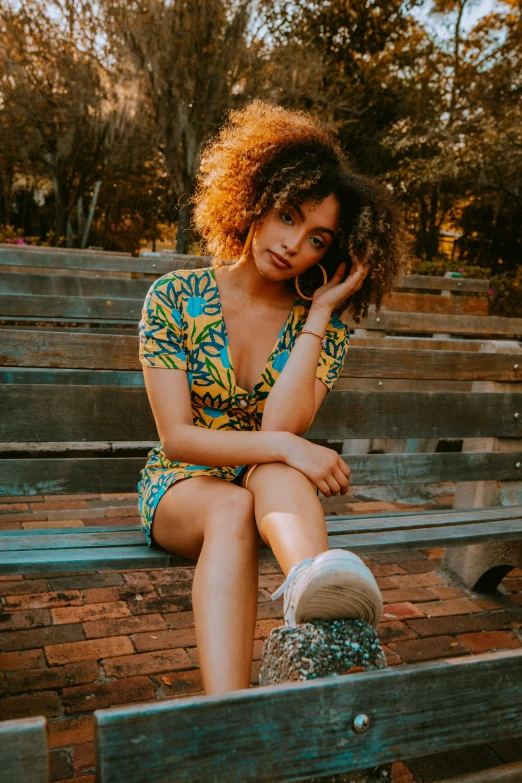 a woman sitting on top of a bench while talking on her phone