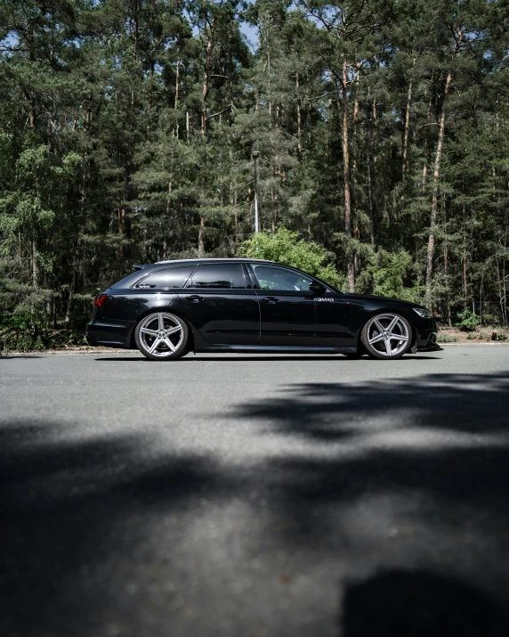 a car parked in front of some trees