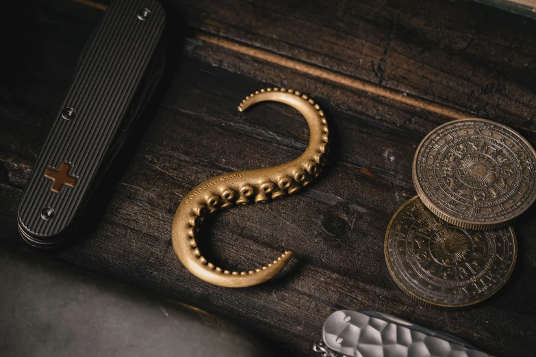 a shiny gold snake on a wooden table