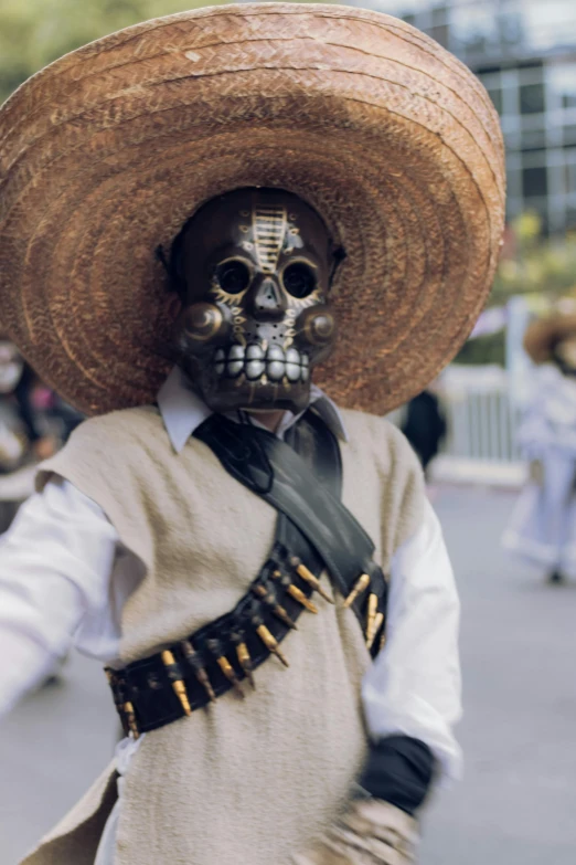 the skull dressed in a mexican gaucho suit walks along a city street