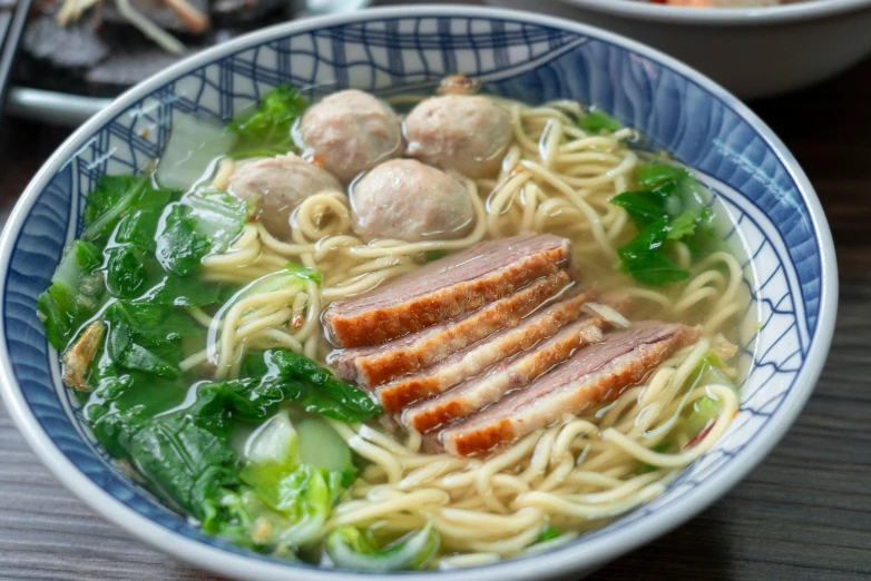 a bowl full of soup with meat and vegetables