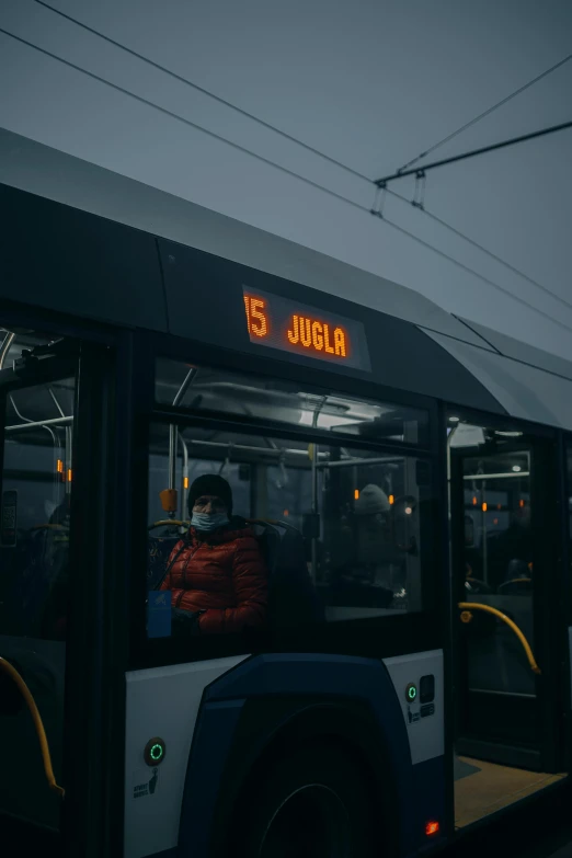 a bus with an open door and a yellow neon sign