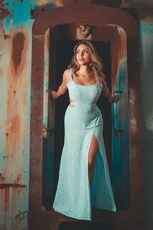 a woman is standing in an old blue door