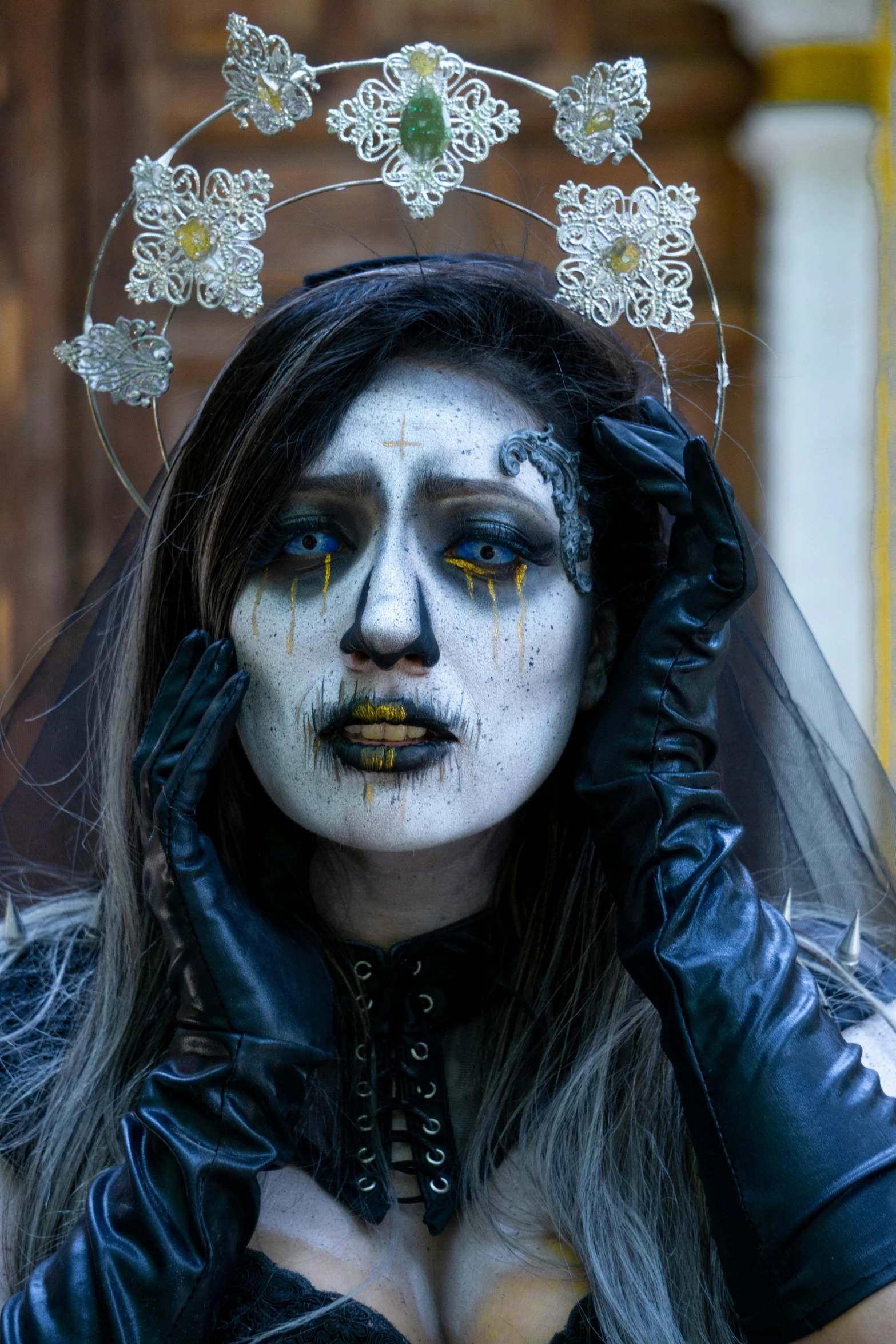 woman with white paint on her face, gloves and hand