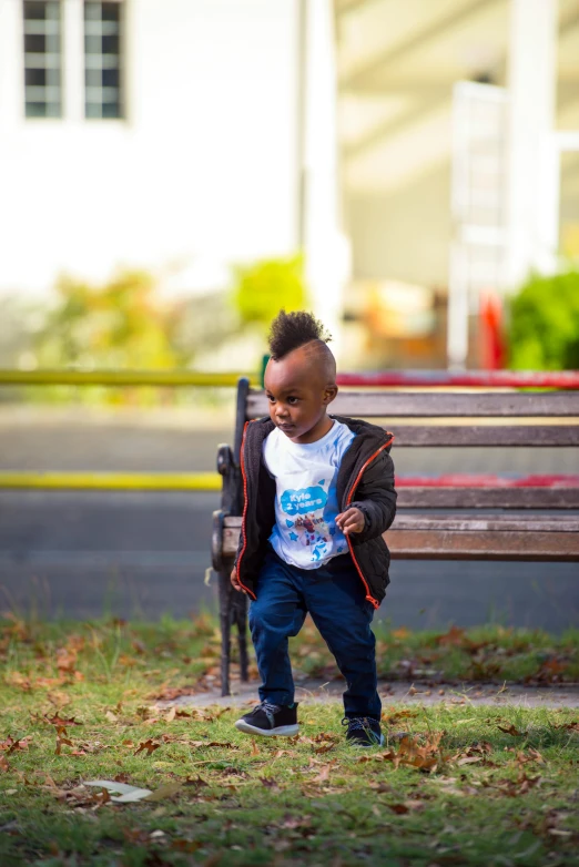 a young child standing near a park bench