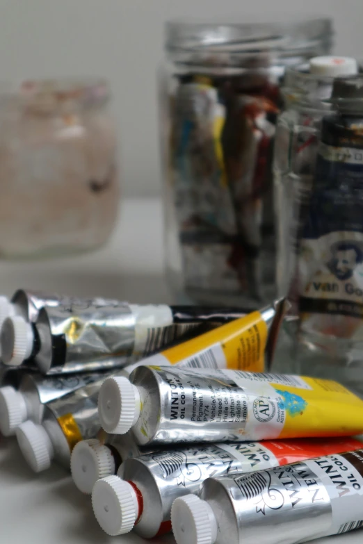 a close up of many tubes of various types of paint