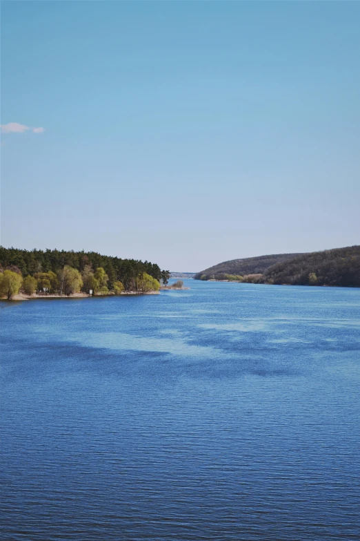 a boat sailing across a large blue body of water