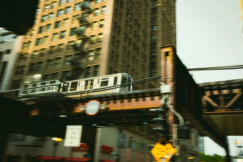 a train passing over a bridge with a city skyscr in the background