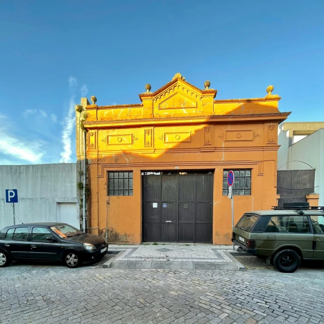 a couple of cars are parked outside of a building