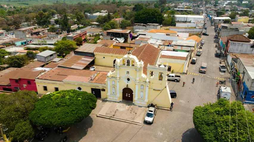 a city with several buildings and cars parked near one another