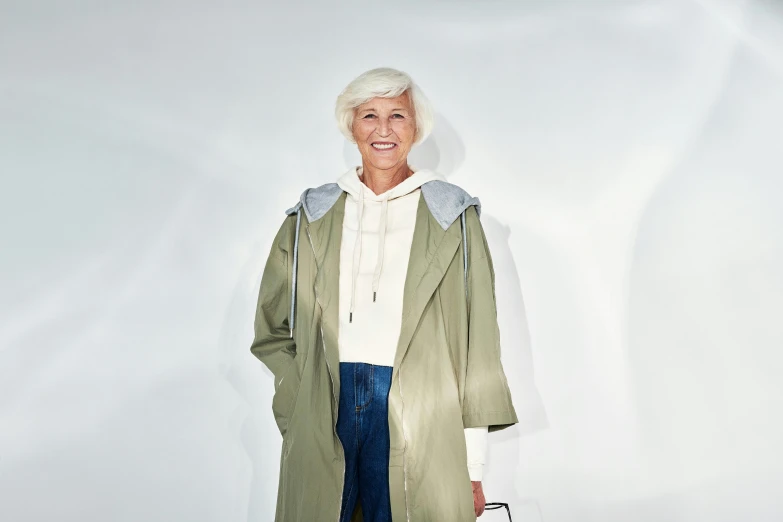 an older lady in a green coat standing