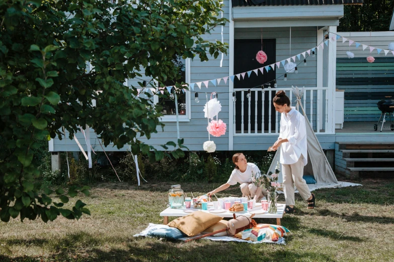 a couple is having their picnic in front of the house