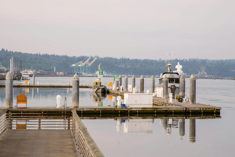 two boats sitting in the water on a dock