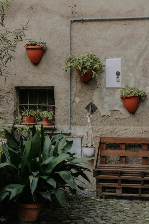 some red planters hanging on the side of a building