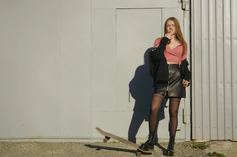 a girl in short skirt with a skateboard