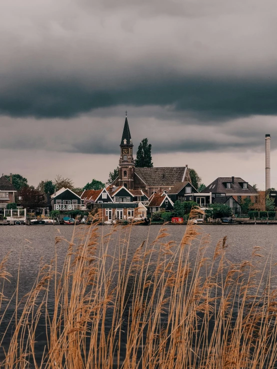 a church with many buildings beside it on the water