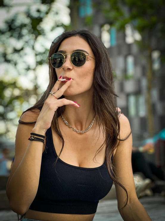 a woman sitting in the street smoking a cigarette