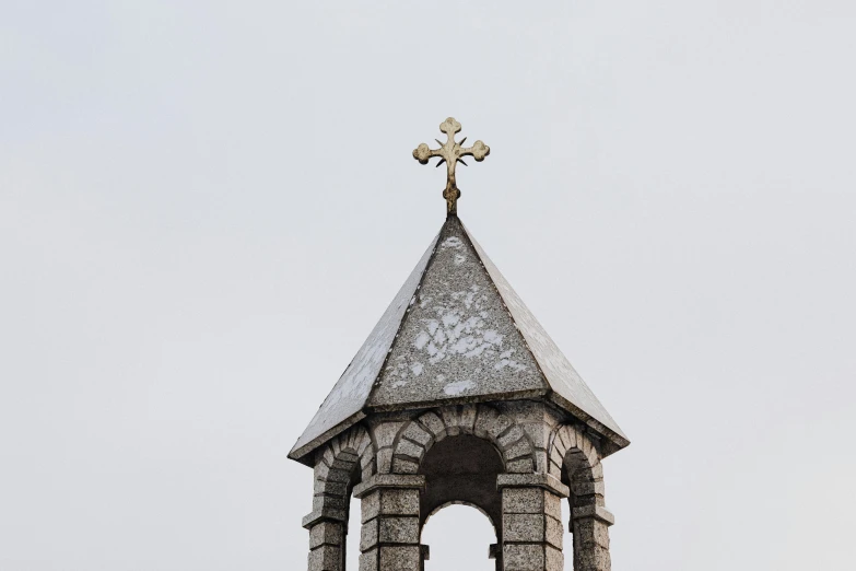 an old and decorative bell tower with a cross on it