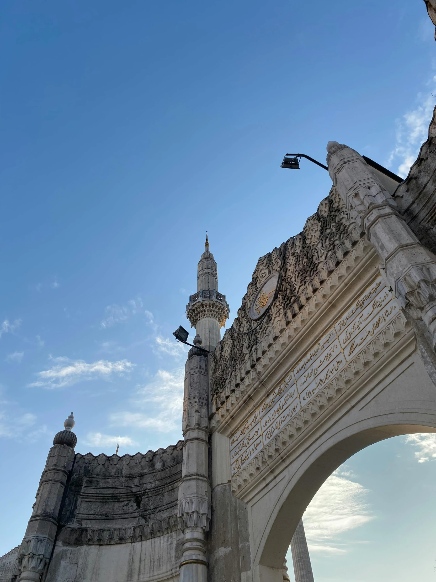 a tower with a clock sitting next to an archway