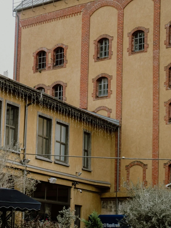 two brown buildings with white trim and a clock