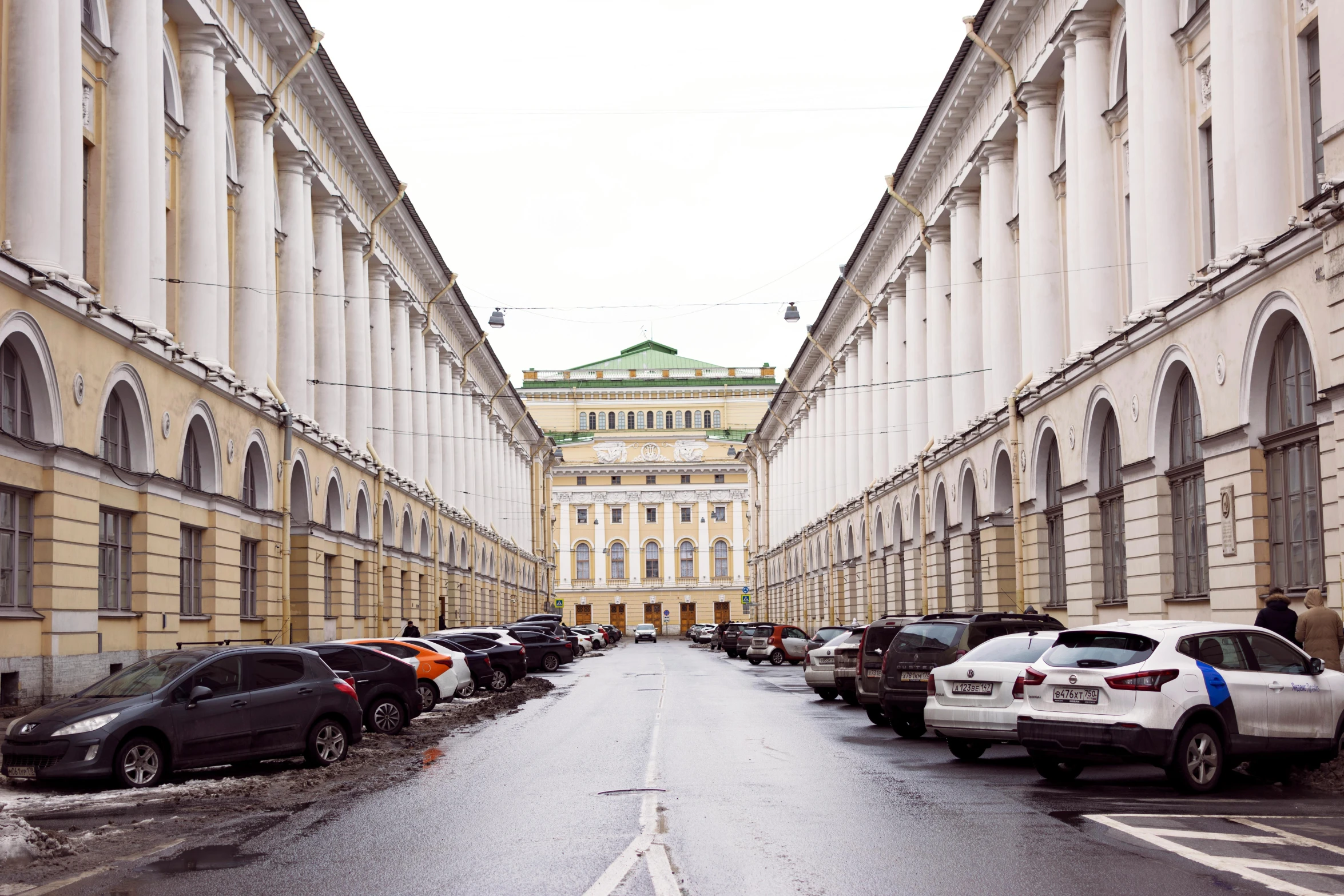 cars parked in a row along an empty street