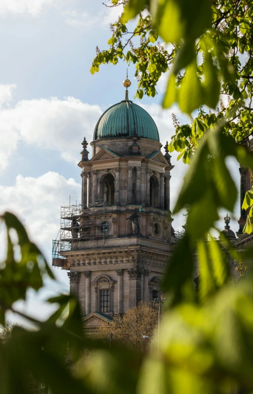 a clock tower sits high on a clear day