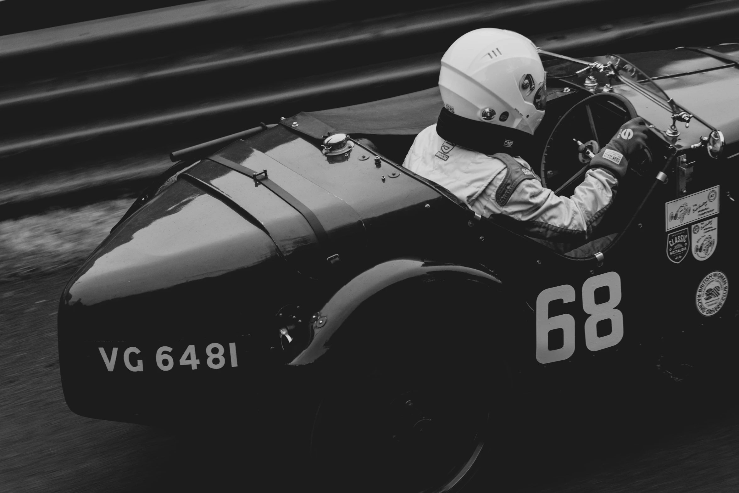 a black and white po of a racer driving