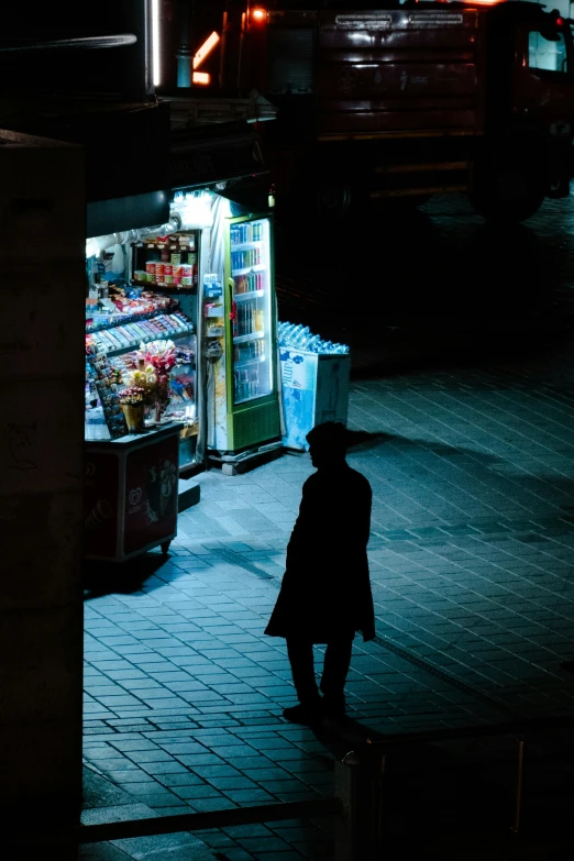 the woman is looking at some type of refrigerator outside