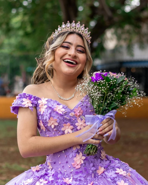 a woman in a purple dress and flower crown is looking at soing