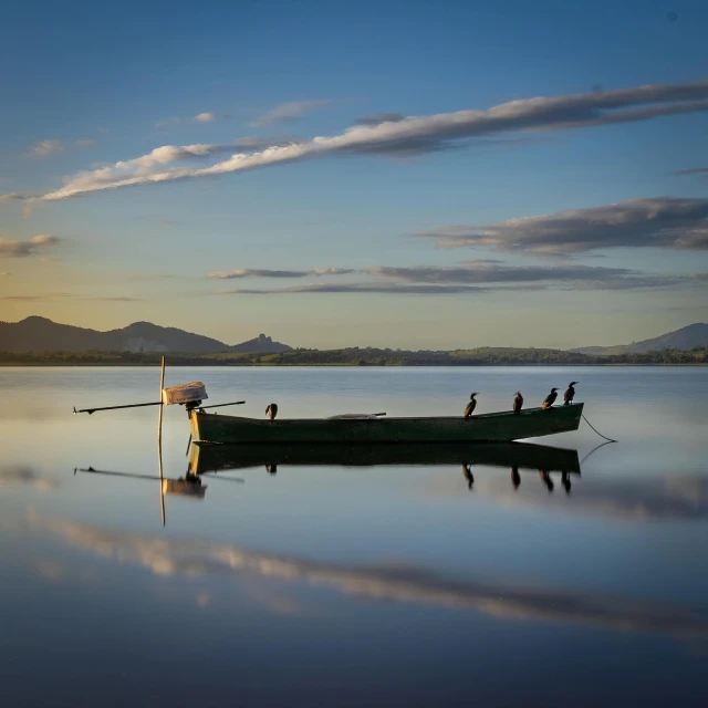 a small boat is sitting in the water