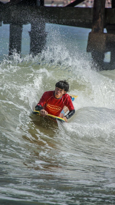 a boy riding a surf board in the water