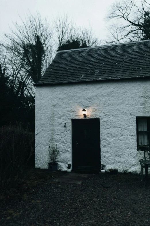 two lamps shining from the windows of a building