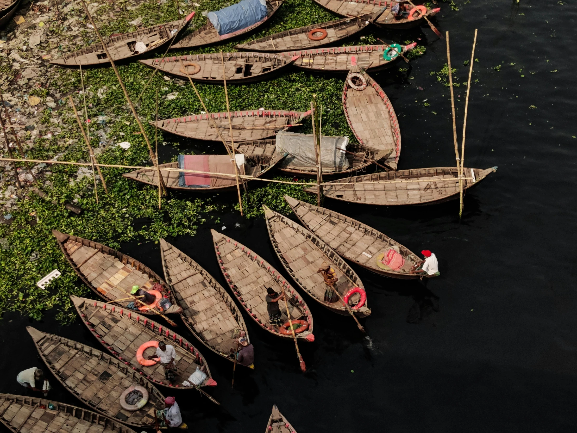 a row of wooden boats docked in the water