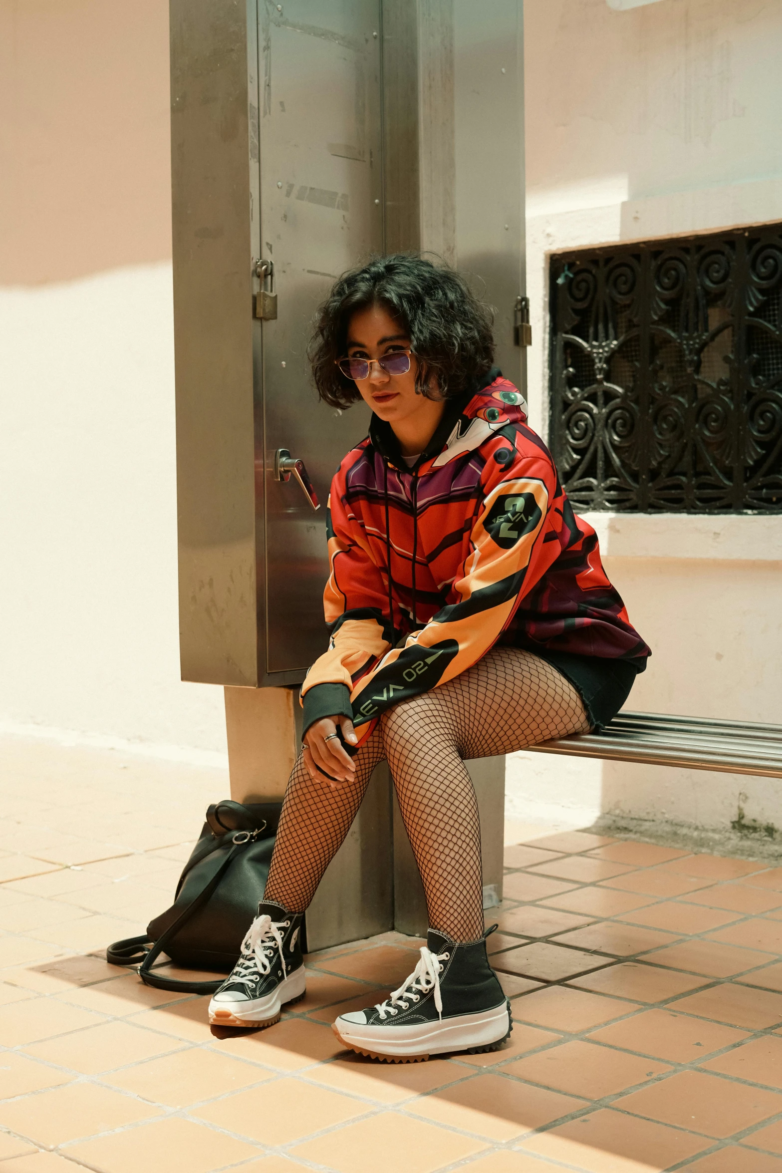 an older woman sitting on the corner of a building