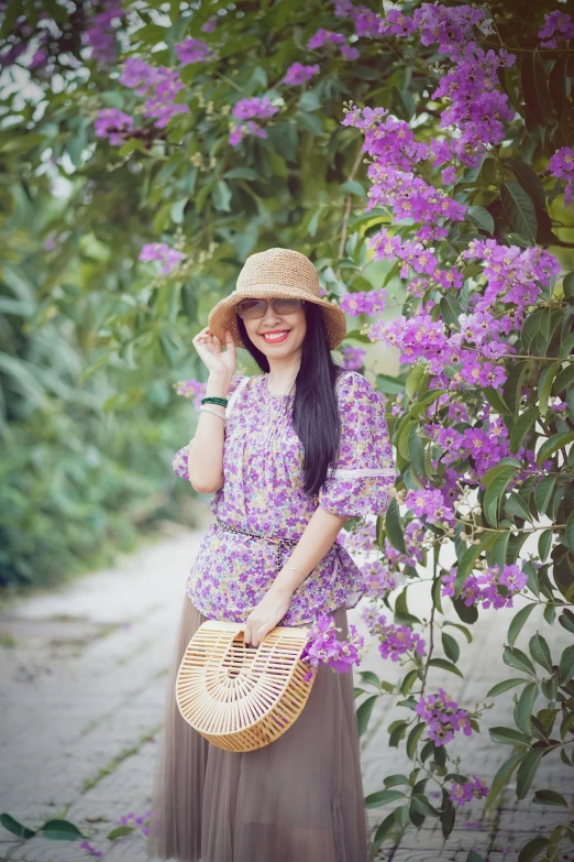 a girl posing with flowers in the background