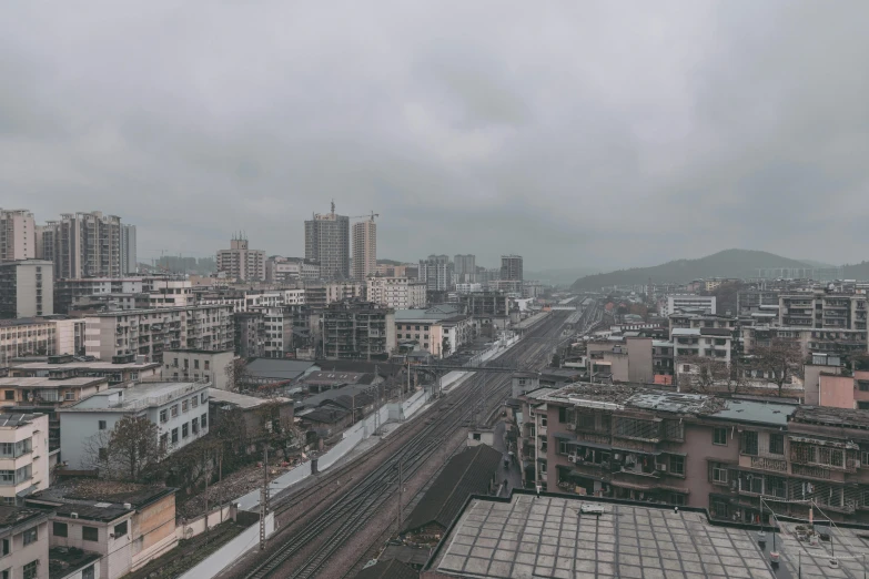 an urban city is shown as dark clouds loom over it