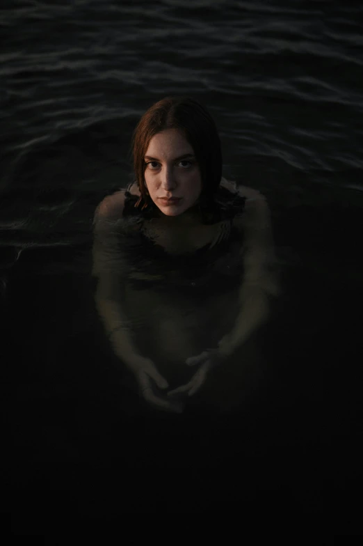 a woman in the water staring to her left