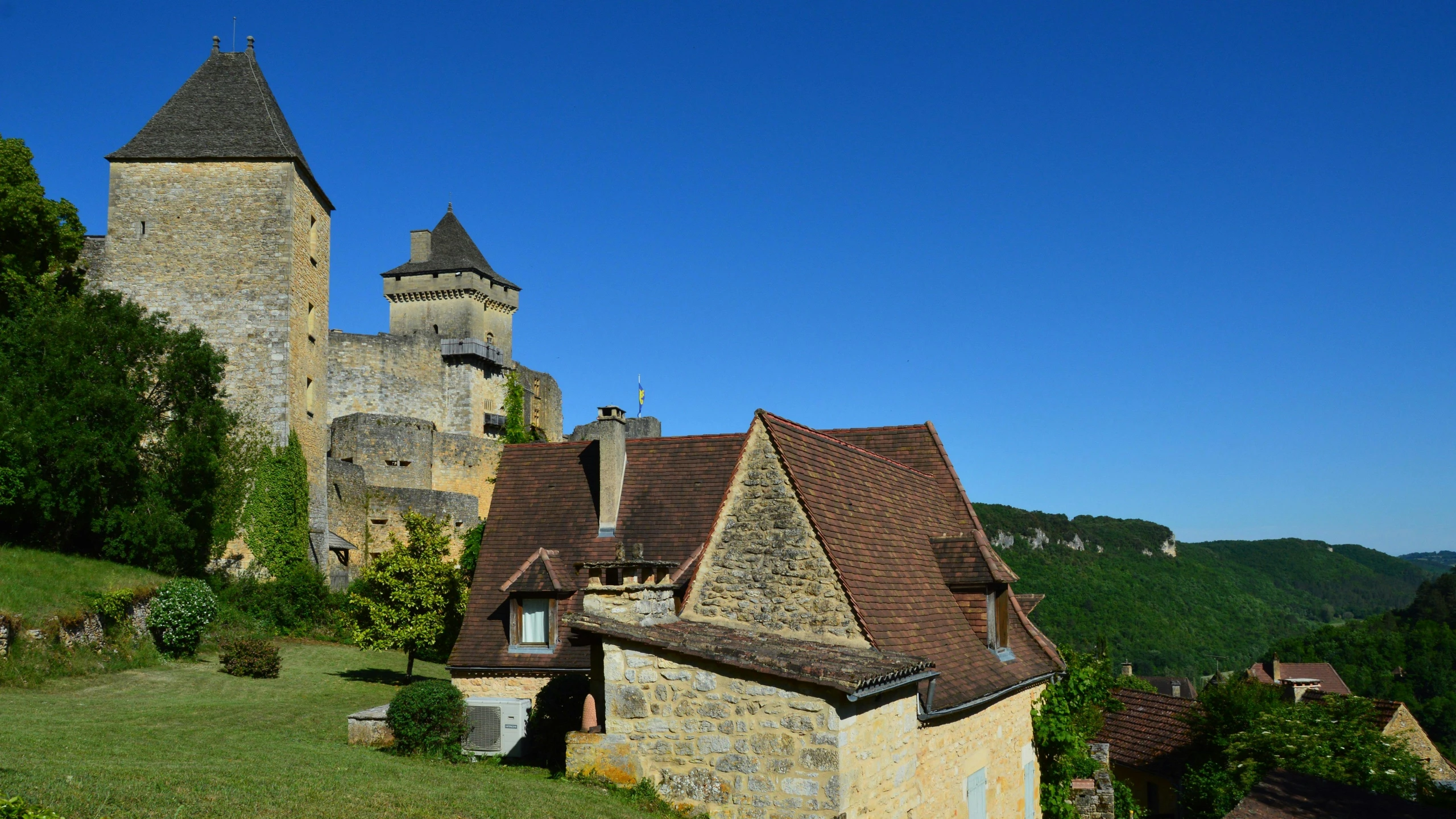 a building on top of a lush green hillside