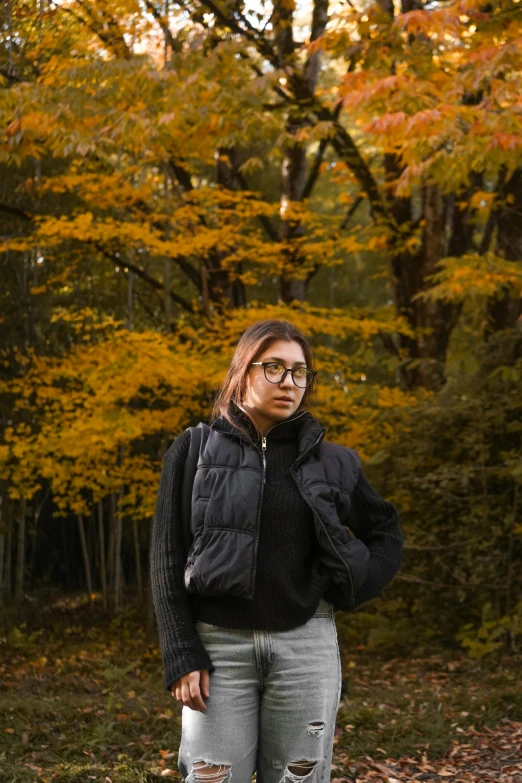 a person is standing in the grass wearing glasses