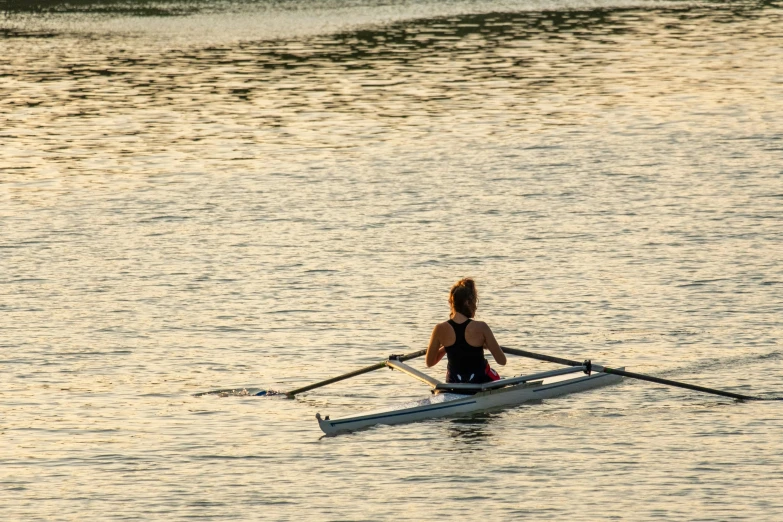 a woman rowing a boat in the water