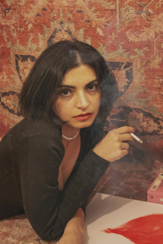 a woman in black top smoking a cigarette