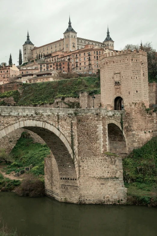 a large stone bridge spanning over a river