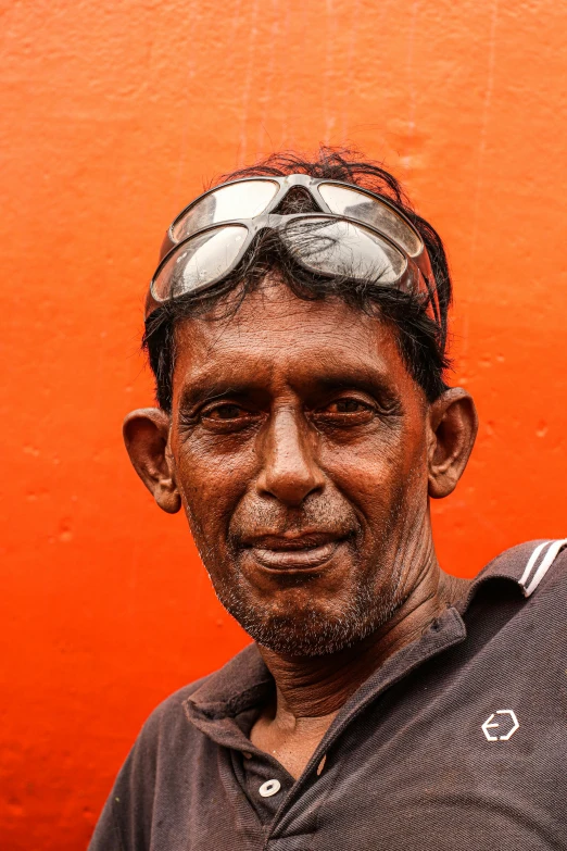 a man in goggles with an orange background