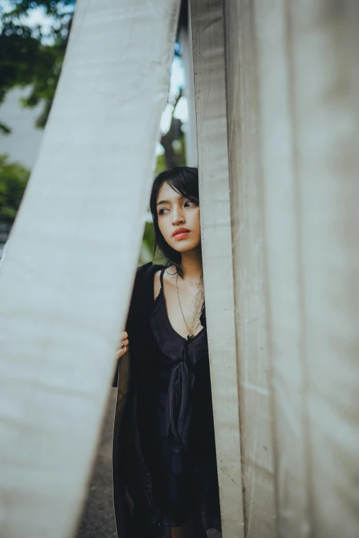 young woman standing at a wall behind another one