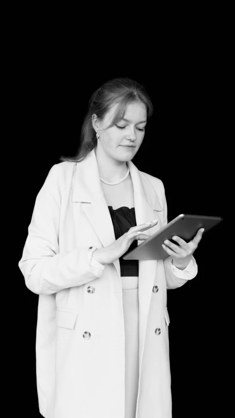 black and white pograph of a woman using a tablet
