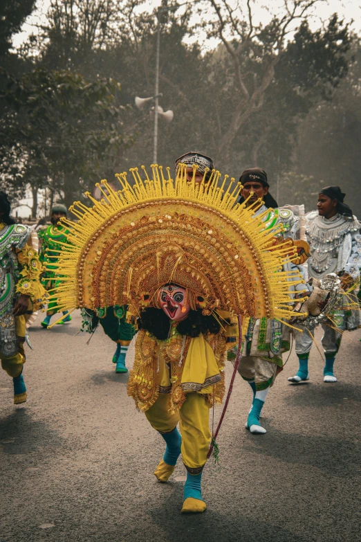 the person is dressed in elaborately colored clothing